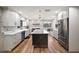 Bright, spacious kitchen with stainless steel appliances, quartz counters, and brick backsplash at 1635 Hilltop Dr, Mount Dora, FL 32757