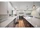 Large kitchen with stainless appliances, big island, white counters and cabinets and brick backsplash at 1635 Hilltop Dr, Mount Dora, FL 32757