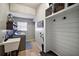 Well-organized laundry room with shelving and storage, sink, washer, and convenient access to essentials at 1635 Hilltop Dr, Mount Dora, FL 32757