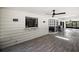Bright screened-in porch with ceiling fans and wood-look tile flooring at 1635 Hilltop Dr, Mount Dora, FL 32757