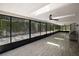Spacious screened-in porch with skylights, ceiling fans, and wood-look tile flooring at 1635 Hilltop Dr, Mount Dora, FL 32757