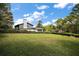 Expansive backyard showcasing a well-maintained lawn and mature trees at 1635 Hilltop Dr, Mount Dora, FL 32757