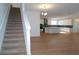 View of carpeted stairs leading to open concept kitchen at 2099 Keystone Pass Blvd, Minneola, FL 34715