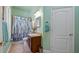 Cozy bathroom featuring a shower with floral curtain, vanity, and towel rack at 23321 N Buckhill Rd, Howey In The Hills, FL 34737
