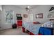 Bedroom featuring a red dresser and bedframe, ceiling fan and a view to the outside at 23321 N Buckhill Rd, Howey In The Hills, FL 34737