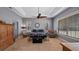 Main bedroom with tray ceiling, carpet floors, and large windows with neutral colors at 23321 N Buckhill Rd, Howey In The Hills, FL 34737