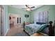 Bedroom featuring hardwood floors, ceiling fan, and ensuite bathroom at 23321 N Buckhill Rd, Howey In The Hills, FL 34737