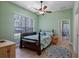 Bright bedroom featuring a ceiling fan, large window, and comfortable furnishings at 23321 N Buckhill Rd, Howey In The Hills, FL 34737
