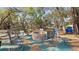 Inviting backyard fire pit area for outdoor gatherings with mature trees and cozy seating at 23321 N Buckhill Rd, Howey In The Hills, FL 34737