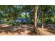 Charming home exterior with mature trees and landscaping providing shade at 23321 N Buckhill Rd, Howey In The Hills, FL 34737