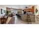 Eat-in kitchen with tile floors, stone breakfast bar, and stainless steel appliances at 23321 N Buckhill Rd, Howey In The Hills, FL 34737