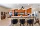 Eat-in kitchen boasts stone bar, granite counters, and updated black appliances at 23321 N Buckhill Rd, Howey In The Hills, FL 34737