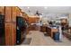 Large kitchen with wooden cabinets, black appliances, and bar seating area at 23321 N Buckhill Rd, Howey In The Hills, FL 34737