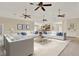 Spacious living area with neutral tones, modern sofas, and access to kitchen at 23321 N Buckhill Rd, Howey In The Hills, FL 34737