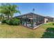 Spacious backyard with a screened-in pool area, perfect for enjoying outdoor living and entertaining at 1786 Red Clover Ln, The Villages, FL 32163