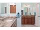 Spacious bathroom with dual vanities, granite countertops, and modern fixtures at 1786 Red Clover Ln, The Villages, FL 32163