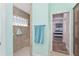 A bright bathroom featuring a walk-in shower with glass block window and tiled walls at 1786 Red Clover Ln, The Villages, FL 32163