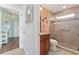 Modern bathroom featuring a glass-enclosed shower, tile surround and vanity with marble countertops at 1786 Red Clover Ln, The Villages, FL 32163