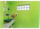 Bathroom featuring a decorative green glass bowl sink, granite countertops, and bright green paint at 1786 Red Clover Ln, The Villages, FL 32163