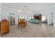 Open concept dining room with view into the living room and pool at 1786 Red Clover Ln, The Villages, FL 32163