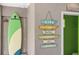 Charming outdoor area featuring a surfboard and coastal-themed wall art near the entrance at 1786 Red Clover Ln, The Villages, FL 32163
