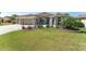 Charming single-story home featuring a well-manicured lawn, mature landscaping and covered entry at 1786 Red Clover Ln, The Villages, FL 32163