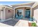 Inviting front porch with comfortable seating, stylish decor, and charming curb appeal at 1786 Red Clover Ln, The Villages, FL 32163