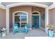 Charming front porch with stylish seating, decorative accents, and a welcoming entrance at 1786 Red Clover Ln, The Villages, FL 32163