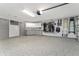 Spacious three-car garage with epoxy flooring, storage racks, utility sink and additional storage at 1786 Red Clover Ln, The Villages, FL 32163