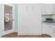 Built-in white cabinets and hardwood floors in home office at 1786 Red Clover Ln, The Villages, FL 32163