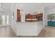 Open kitchen featuring granite countertops, modern appliances, and wood cabinets at 1786 Red Clover Ln, The Villages, FL 32163