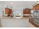 Bright kitchen featuring granite counters, stainless steel appliances, and light-filled breakfast nook at 1786 Red Clover Ln, The Villages, FL 32163