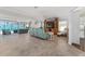 Spacious living room with large sliding doors leading to the screened lanai and pool area at 1786 Red Clover Ln, The Villages, FL 32163