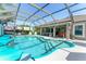 Beautiful screened-in pool with a tiki bar and plenty of space for entertaining guests outdoors at 1786 Red Clover Ln, The Villages, FL 32163