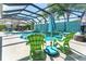 Inviting screened-in pool area featuring turquoise accents and shaded lounge seating for relaxing and entertaining at 1786 Red Clover Ln, The Villages, FL 32163