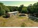 Large metal outbuilding with multiple roll-up doors, providing ample storage or workspace on the property at 1921 Smitty Rd, Lady Lake, FL 32159