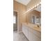 Bathroom features a double vanity, large mirror and a shower and tub at 4953 Glen Coe St, Leesburg, FL 34748