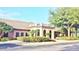 Clubhouse with a covered entrance, brick and stone exterior, and manicured landscaping at 4953 Glen Coe St, Leesburg, FL 34748