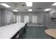 Bright community room with tables, chairs, storage cabinets, and multiple windows, perfect for meetings and activities at 4953 Glen Coe St, Leesburg, FL 34748
