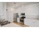 Bright kitchen features white cabinetry, stainless steel appliances, and tile flooring at 4953 Glen Coe St, Leesburg, FL 34748