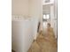 The laundry room has tan tile flooring and a white washer and dryer at 4953 Glen Coe St, Leesburg, FL 34748