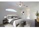 Main bedroom offers natural light with a fan, big windows, and two ottomans at 4953 Glen Coe St, Leesburg, FL 34748