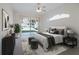 This main bedroom features a ceiling fan, big windows, and a relaxing aesthetic at 4953 Glen Coe St, Leesburg, FL 34748
