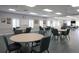 Community meeting room with tables, chairs, and natural light at 4953 Glen Coe St, Leesburg, FL 34748