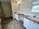 Bathroom boasts dual sinks, a large vanity, and updated flooring at 4422 Cr 690, Webster, FL 33597