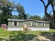 Single-wide manufactured home with neutral exterior and wooden steps at 4422 Cr 690, Webster, FL 33597