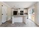 Kitchen features white cabinets, an island, and black appliances at 4422 Cr 690, Webster, FL 33597