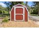 Red and white barn-style shed, perfect for extra storage at 4422 Cr 690, Webster, FL 33597