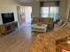 Living area with hardwood floors and comfortable seating at 5596 Cedar Waxwing Dr, The Villages, FL 32163