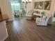 Relaxing seating area with hardwood floors and coastal decor at 5596 Cedar Waxwing Dr, The Villages, FL 32163